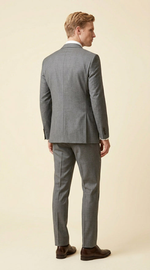Man wearing the F.Ferrante FEU230 tailored two-button suit in grey, styled with a white shirt, charcoal tie and dark brown Oxford shoes